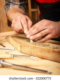 Close Up Of Carpenter Restoring Old Furniture