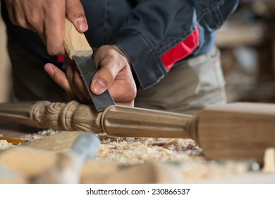 Close up carpenter's hands that work with cutter
