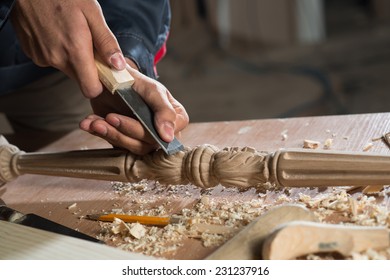 Close up carpenter's hands that work with cutter