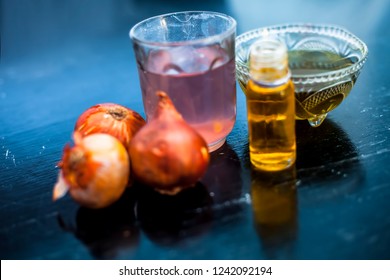 Close Up Of Caster Oil,onion Juice Mixture Used To Make Hair Stronger And Thicker On Wooden Surface.;