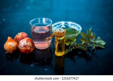 Close Up Of Caster Oil,onion Juice Mixture Used To Make Hair Stronger And Thicker On Wooden Surface.;