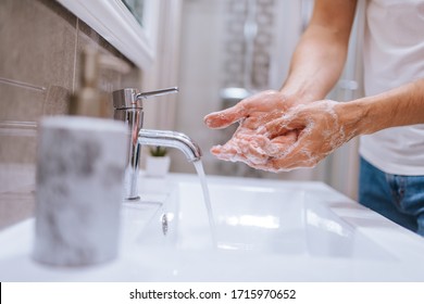 Close Up Of Caucasian Man Washes His Hands In The Bathroom. COVID - 19 Prevention