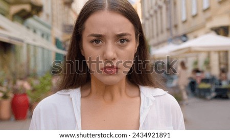 Close up Caucasian unhappy girl street city annoyed woman frowning emotions displeased disappointed dissatisfied angry female envy irritation bad reaction serious expression confident negative pensive
