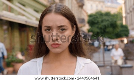 Close up Caucasian unhappy girl street city annoyed woman frowning emotions displeased disappointed dissatisfied angry female envy irritation bad reaction serious expression confident negative pensive