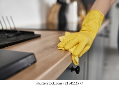 Close up of caucasian woman cleaning kitchen at home 