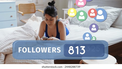 Close up of a Caucasian woman lying in bed while texting on her phone. Bellow her in the foreground is a digital image of a followers count bar with icons flying upwards