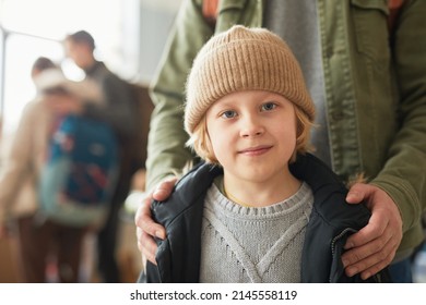 Close up of Caucasian young boy with dad looking at camera at help center for refugees, copy space - Shutterstock ID 2145558119