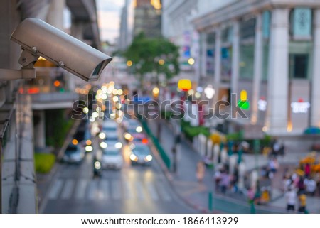 Close up CCTV security camera with blur of traffic jam in the background, Traffic security camera surveillance (CCTV) in the big city.