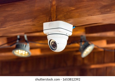 Close Up Of CCTV Security Camera On The Ceiling In The Building. Record Video All Day And Night. Stay Always Safe Concept.