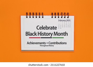 Close up of Celebrate Black History Month sign on orange background