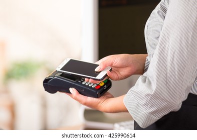 Close Up Of Cell Phone Contact With Credit Card Machine, Easy Way To Pay