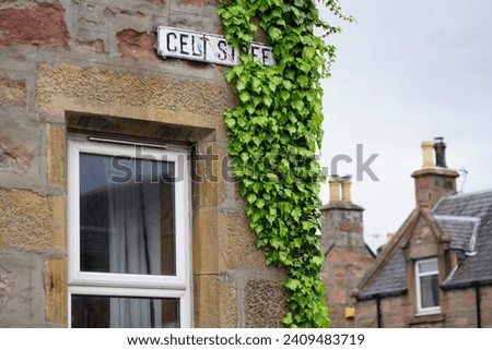 Close up of Celt street sign on ivy covered stone house in Inverness, Scotland
