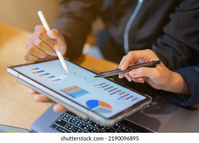 close up ceo businesswoman hand point on dashboard screen tablet device for ask and share idea or consulting with businessman partner for business team and work from home concept - Shutterstock ID 2190096895