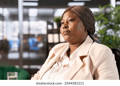 Close up of CEO in office developing and implementing business strategies to improve operational efficiency and profitability. African american businesswoman having management executive role