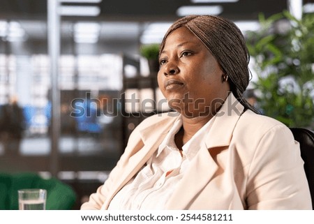 Close up of CEO in office developing and implementing business strategies to improve operational efficiency and profitability. African american businesswoman having management executive role