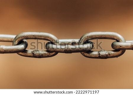 Close up chain links on sepia colored backdrop as old connection concept