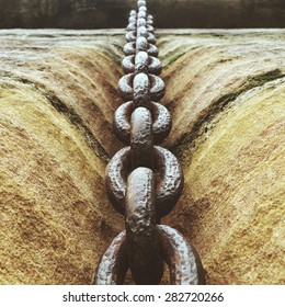 Close up of a chain on the wall Processed with VSCOcam with m3 preset