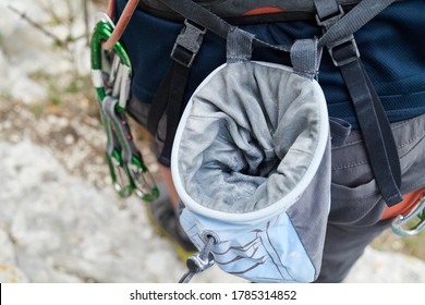 Close Up Of Chalk Bag Ready For Practice Rock Climbing On Artificial Wall Outdoors. Active Lifestyle And Bouldering Concept. Mountain Rock Climbing Detail. Climber With Her Climbing Gear And Equipment