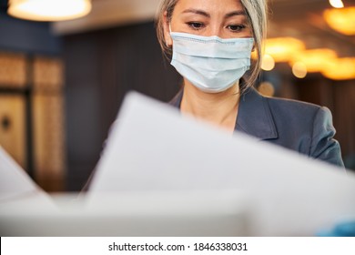 Close Up Of Charming Woman Wearing Protective Face Mask While Holding Papers