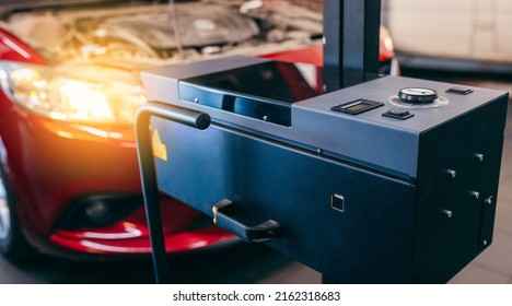 Close up checking and adjusting the headlights of a car's lighting system in auto repair service. - Shutterstock ID 2162318683