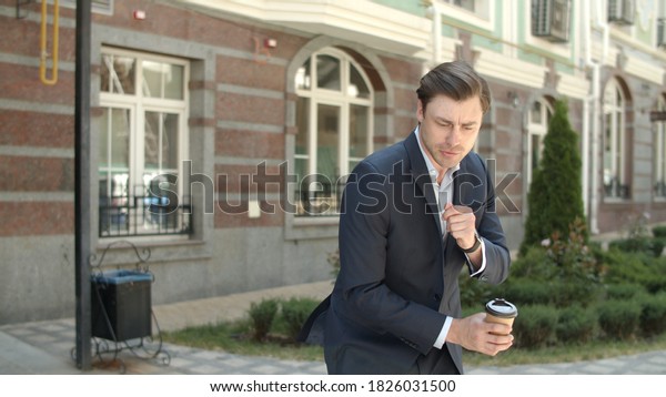 Close up cheerful\
businessman going to work with cup coffee outdoor. Happy business\
man dancing with coffee before work outdoor. Joyful man going to\
job with coffee at\
street.