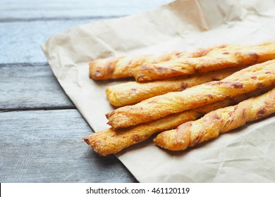 Close Up Of Cheese Bread Sticks On A Wooden Background.