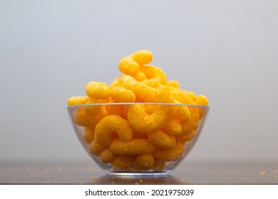 Close Up Of Cheese Puffs In Glass Bowl.