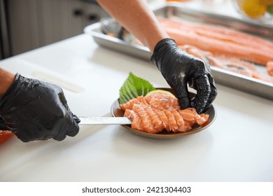 close up chef cooking raw salmon fish and decorate dish in the kitchen - Powered by Shutterstock