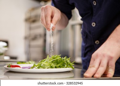 Close Up Chef Preparing Food In Kitchen