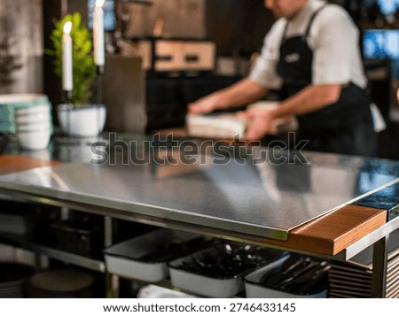 Close up of chef work table in restaurant kitchen, professional stainless steel surface for food preparation and culinary work.