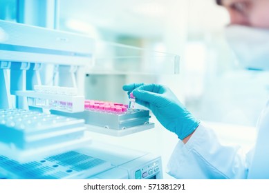 Close Up Of Chemist Scientist Holding Sample And Examining Test Tube In Special Laboratory