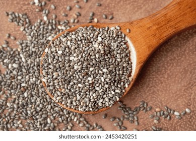 Close up of chia seeds in a wooden spoon. Chia seeds contain fibre and omega-3 fatty acids, protein, many essential minerals and antioxidants. Healthy eating concept. 