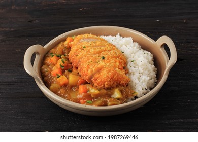 Close Up Chicken Katsu With Japanese Curry, Serve With White Rice On Brown Ceramic Plate Above Wooden Table, Isolated With COpy Space For Text Or Recipe