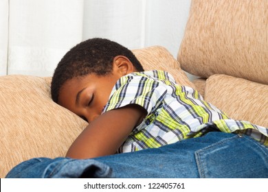 Close Up Of Child Boy Sleeping On Sofa.