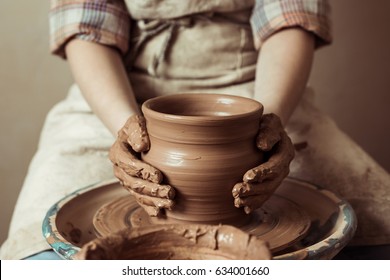 Close Up Of Child Hands Working On Pottery Wheel At Workshop