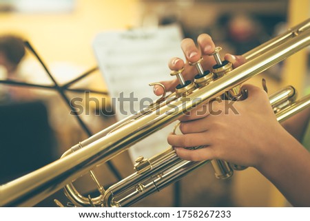 Close up of a child playing a trumpet 