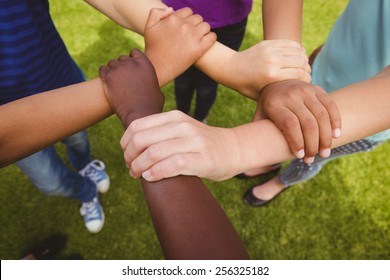 Close Up Of Children Holding Hands Together At The Park