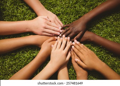 Close Up Of Children Keeping Hands Together Over Grass