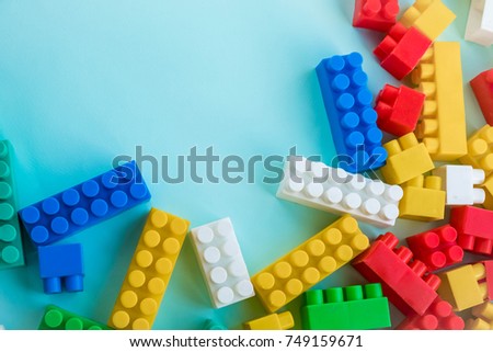 Close up Children plastic constructor. on a blue background stripe background. Developing toys.