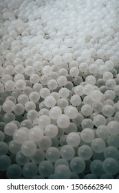 Close Up Of A Childrens Ball Pit Filled With Only White Balls To Look Like Bath Water With Monochrome Shadows