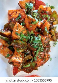 Close Up Of Chilli Paneer And Capsicum Garnish With Coriander