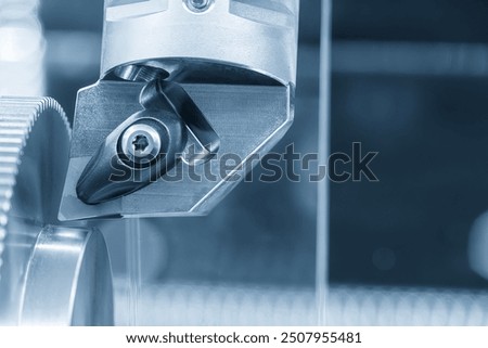 Close up  the  chip insert on the lathe machine in the light blue scene. The high precision mechanical parts manufacturing concept.