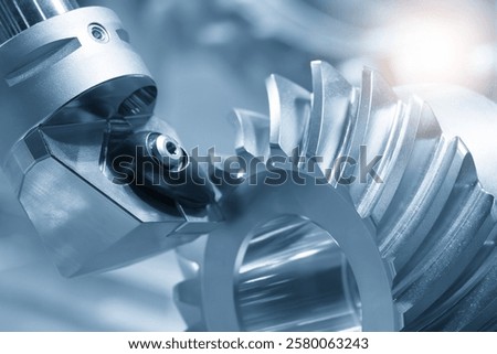 Close up the chip insert tool on the lathe machine cutting the gear parts in the light blue scene. The high precision mechanical parts manufacturing concept.