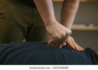 Close up of Chiropractors hands giving adjustment along spine