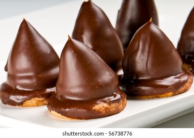 Close Up Of Chocolate Cones, Over Cookie Filled With Caramel.