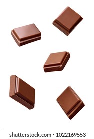 close up of chocolate pieces stack falling on white background - Shutterstock ID 1022169553