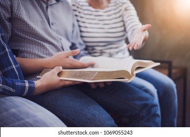 close up of christian group are reading and study bible together on one big bible in Sunday school class room - Shutterstock ID 1069055243