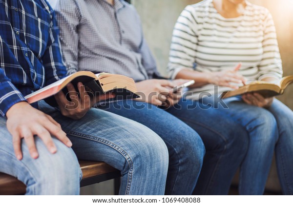 close up of christian group\
are reading and study bible together in Sunday school class\
room\
