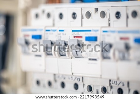 Close up circuit breakers and wire in control panel.