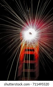 A Close Up Of A Circular Firework Called A Catherine Wheel Which Spins And Sends An Array Of Colours To Light The Night Sky .